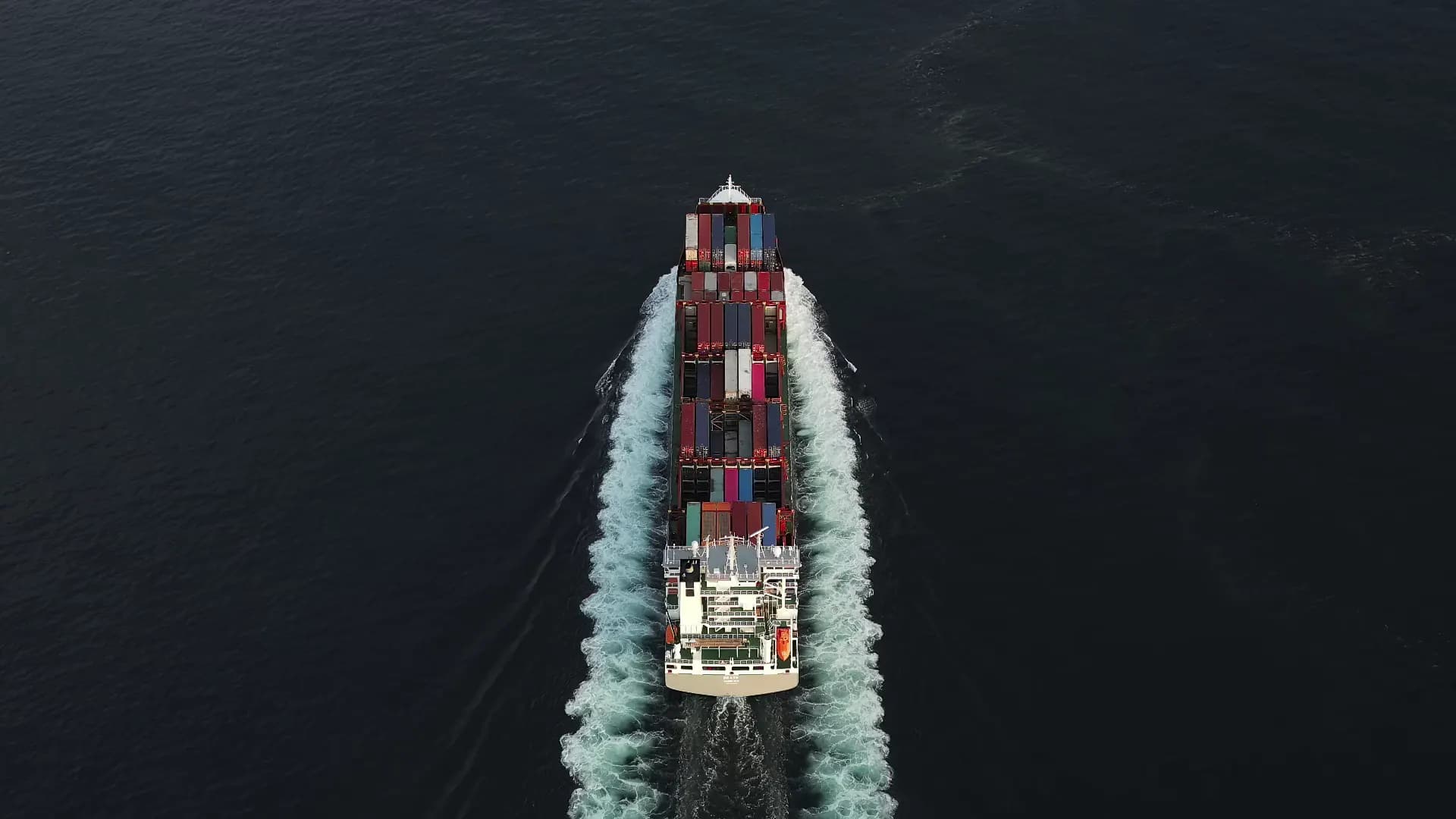 Aerial view of a container ship crossing open water